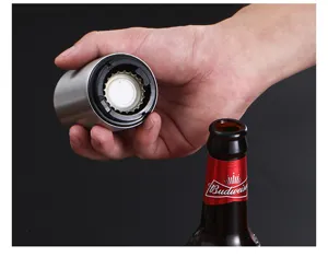 Close-up detail shot of stainless steel push down magnetic beer bottle opener in action.