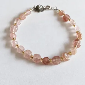 Natural strawberry crystal irregular gemstone beaded bracelet detail, delicate gold spacer beads.