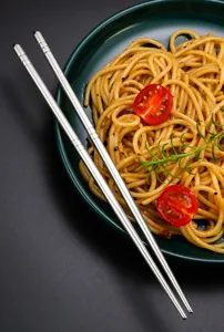 Stainless steel chopsticks detail shot, square hollow non-slip design for kitchen use.