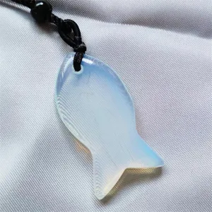 Natural crystal fish pendant necklace detail view, elegant translucent gemstone design.