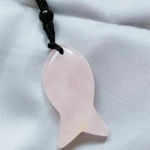 Natural pink crystal fish pendant detail shot, elegant gemstone necklace accessory charm.
