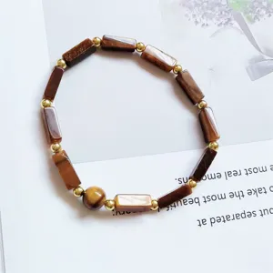 Detailed view of a natural stone rectangular bead bracelet with gold spacer beads.