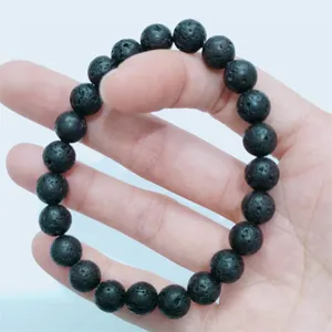 Black lava stone beaded bracelet detail view, natural porous stone unisex design item.