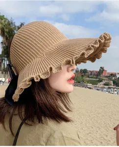 Stylish women's summer knit sun hat with wide ruffle brim and bow detail. Beach empty top visor.