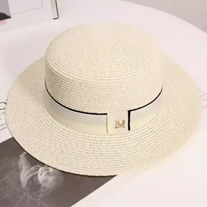 Summer flat top straw hat for women, elegant beach sun hat with metal M logo and ribbon.