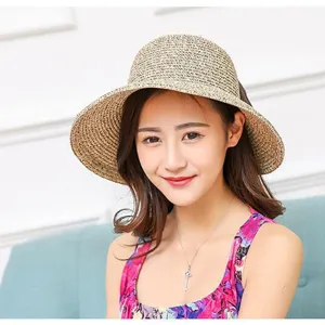 Detail view of the women's summer straw sun hat featuring a stylish bow and woven design.