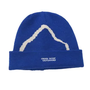 Close-up of blue snow mountain knit beanie with outdoors embroidery detail