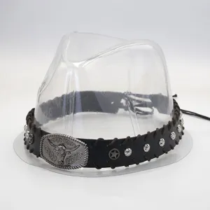 Detailed close-up of retro cowboy hat band with metallic bull buckle and star rivets.