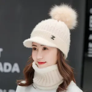 Winter warm knitted hat with visor and pompom, plush lined thick cozy cap detail view.