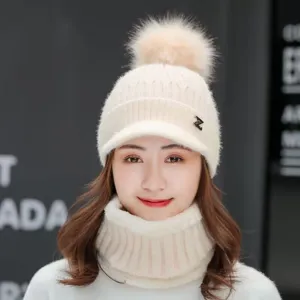 Women winter knitted hat with fleece lining, visor and cute pom-pom detail for cold weather.