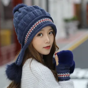 Detail of a stylish blue winter knitted beanie with earflaps and matching fur trim gloves.