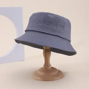Detail view of a classic grey cotton bucket hat, casual sun protection fashion casual cap.