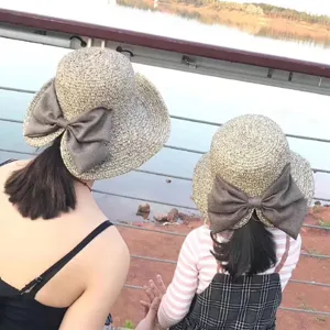 Summer sun straw hat for women and kids with bow, foldable UV protection beach travel hat.
