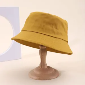 Yellow cotton bucket hat detail, classic solid color casual sun hat for outdoor wear.