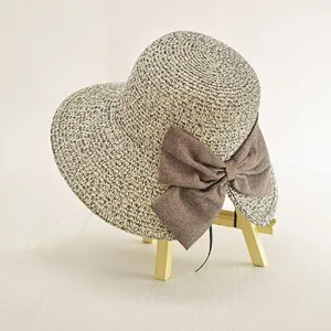 Detailed view of the summer straw hat featuring woven texture and a stylish brown bow.