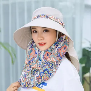 Detailed closeup of summer sun protection hat with floral neck flap, worn by model outdoors.
