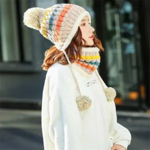 Close-up detail of winter knitted pom-pom hat with ear flaps and matching neck warmer set