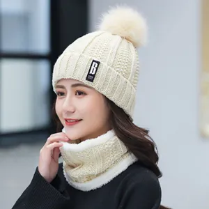 Cozy knitted winter beanie with pom pom and neck warmer set for women, warm fleece lined detail.