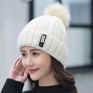 Women winter warm fleece lined knit beanie hat with cute pom pom and stylish letter label design.