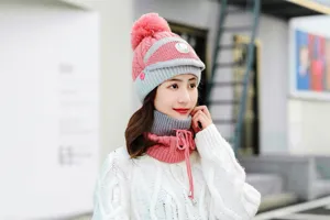 Detailed closeup shot of women winter warm knitted beanie hat with pom pom and matching scarf.