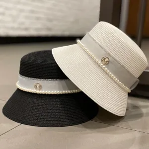 Women summer elegant straw bucket hat with pearl ribbon and M logo detail for sun protection