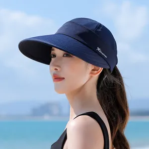 Detail shot of navy blue wide brim empty top sun hat, outdoor beach style uv protection.