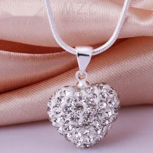 Close-up of shimmering heart-shaped Shamballa pendant with clear crystals on snake chain