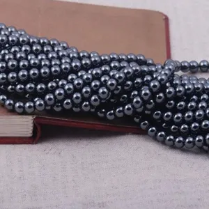 Close-up detail of 10mm round black hematite magnetic stone beads for jewelry making