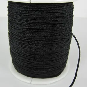 Close-up detail of black braided cord spool for jewelry and Shamballa bracelet making.