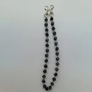 Detailed view of the black acrylic dice chain pendant, showing the close-up dice links.