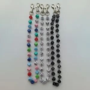 Detailed view of colorful acrylic dice chains with metal lobster clasps for hip-hop pants and bags.