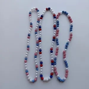 Detailed close-up of colorful rhinestone and pearl beaded necklace, vibrant stylish jewelry.