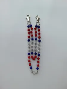 Macro view of 12mm red white blue rhinestone pavé beaded hip hop trousers chain details