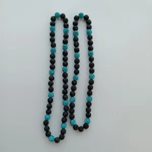 Detail view of the black and turquoise rhinestone shamballa clay bead necklace strand.