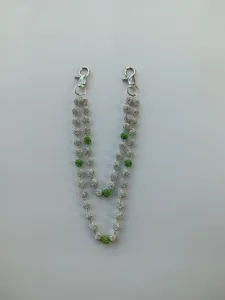 Detail view of a dual-strand 12mm rhinestone disco ball pants chain in silver and green.