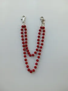 Detailed view of a 12mm red rhinestone double-strand chain with silver lobster clasps.