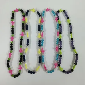Colorful beaded necklace detail featuring sparkling glitter spheres and cross spacer charms.