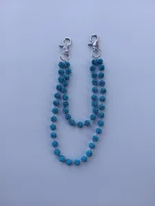 Detail view of the 12mm blue sparkling rhinestone ball chain with silver metal clasps.