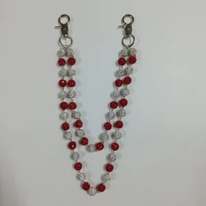 Detailed view of 12mm red and white rhinestone disco ball beads on a hip-hop waist chain.