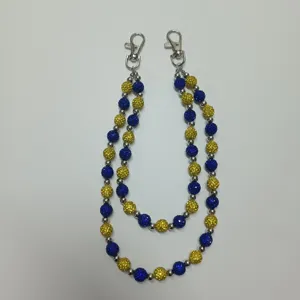 Detail of hip-hop pants chain with blue and yellow rhinestone beads and silver lobster clasps