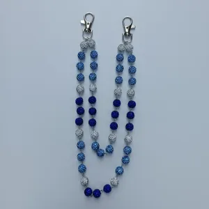 Macro view of 12mm blue rhinestone clay ball pant chain featuring silver lobster clasps