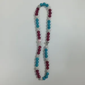 Close-up detail of colorful rhinestone shamballa bead necklace with baseball and cross charm.