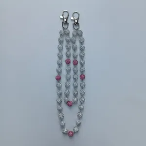 Macro view of two sparkly rhinestone bead chains featuring silver metal swivel lobster clasps.