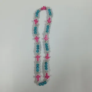 Detailed close-up shot of the colorful beaded cross necklace, showcasing texture and vivid colors.