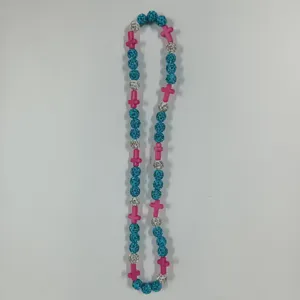 Colorful beaded necklace featuring blue crystal balls, pink cross charms, and sparkling rhinestones.