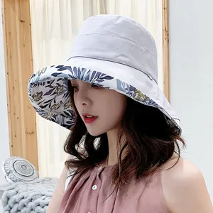 Detail view of the women's sun hat, showing the wide brim and blue floral inner lining.