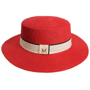 Red straw boater hat with white ribbon and metal M letter decor for women summer beach.