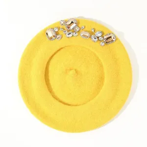 Yellow wool beret detail shot, featuring sparkling crystal rhinestones and gemstone deco.