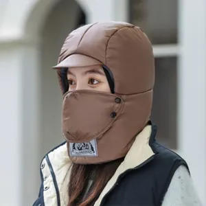 Detailed shot of winter thermal brown trapper hat featuring integrated windproof face mask.