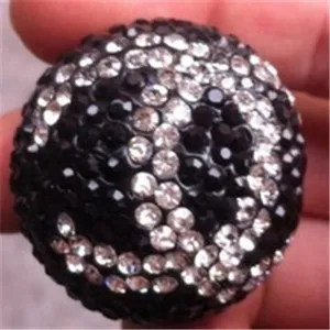 Close-up of a 10mm clay ball bead fully encrusted with black and white rhinestones.